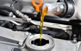Image of oil being pured into engine during a car or 4WD service