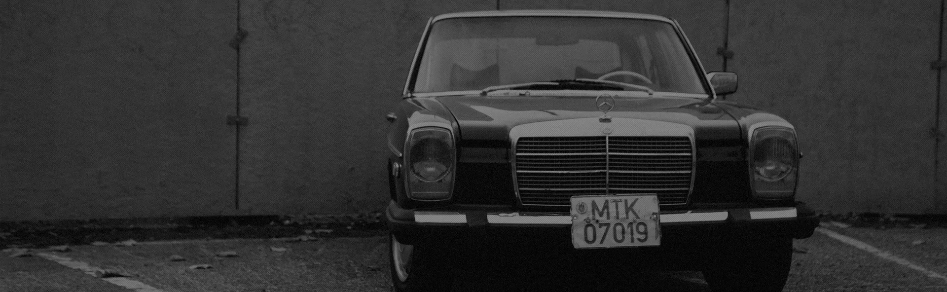 Image of an older Mercedes Benz car ready for a mechanic to fix